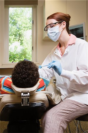 doctor with gloves with child - Boy having teeth examined Stock Photo - Premium Royalty-Free, Code: 6116-08915558