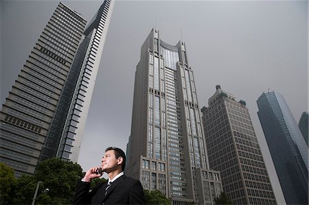 simsearch:6109-06685044,k - Businessman near skyscrapers Stock Photo - Premium Royalty-Free, Code: 6116-09013548