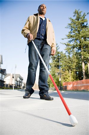 Blind man using a walking stick Stock Photo - Premium Royalty-Free, Code: 6116-09013594