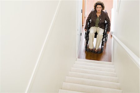 simsearch:6113-07243220,k - Disabled woman trapped at bottom of stairs Stock Photo - Premium Royalty-Free, Code: 6116-09013596