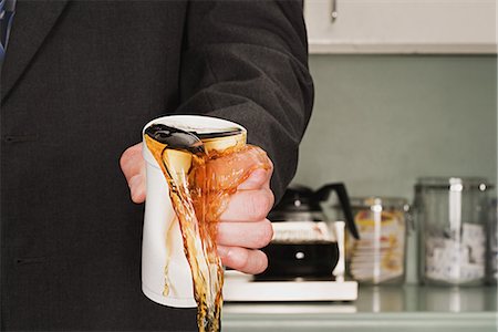Businessman crushing coffee cup Stock Photo - Premium Royalty-Free, Code: 6116-09013652