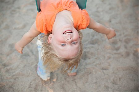 person upside down - A Child Playing Outdoors. A Girl Hanging Upside Down On A Swing. Stock Photo - Premium Royalty-Free, Code: 6118-07121884