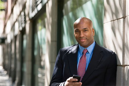 simsearch:6118-07121993,k - Business People. A Businessman In A Suit And Red Tie, Checking His Phone. Stock Photo - Premium Royalty-Free, Code: 6118-07121998