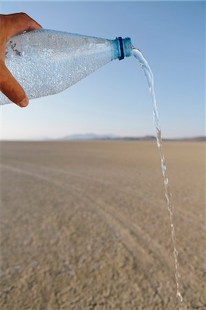 The Landscape Of The Black Rock Desert In Nevada. A Bottle Of Water Being Poured Out. Filtered Mineral Water. Stock Photo - Premium Royalty-Free, Code: 6118-07122057