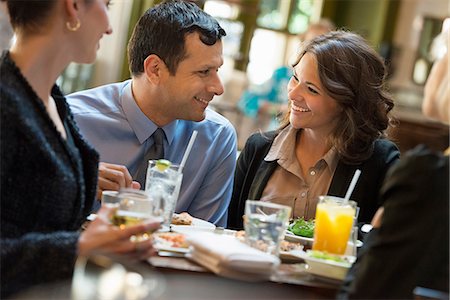 simsearch:6118-07122298,k - Business People. Four People, A Man And Three Women Sitting At A Table. Stock Photo - Premium Royalty-Free, Code: 6118-07122010