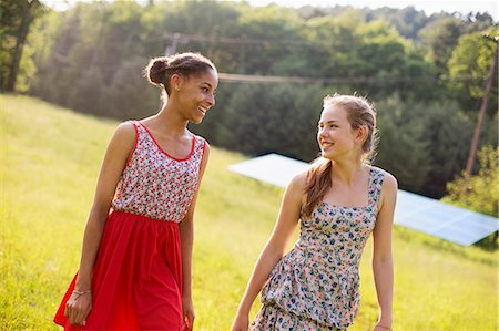 Two Young Girls On The Farm, Outdoors. A Large Solar Panel In The Field Behind Them. Stock Photo - Premium Royalty-Free, Code: 6118-07122253