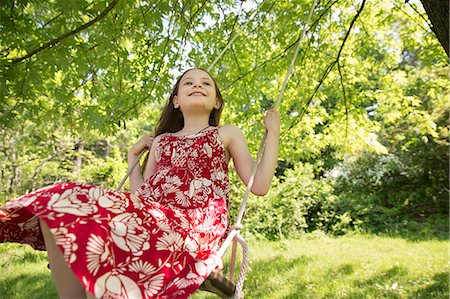 farm of america - Summer. A Girl In A Sundress On A Swing Suspending From The Branches Of A Tree. Stock Photo - Premium Royalty-Free, Code: 6118-07122204