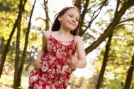 simsearch:6118-07351124,k - A Young Girl Running Along Through Trees On A Farm. Stock Photo - Premium Royalty-Free, Code: 6118-07122215