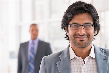 Business People. A Man In A Light Jacket Wearing Glasses. Stock Photo - Premium Royalty-Free, Code: 6118-07122368