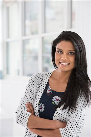 Business People. A Young Woman With Long Dark Hair. Smiling. Stock Photo - Premium Royalty-Free, Code: 6118-07122374