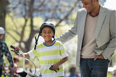 simsearch:400-06412547,k - Bicycling And Having Fun. A Father And Son Side By Side. Stock Photo - Premium Royalty-Free, Code: 6118-07122486