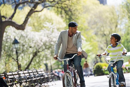 people boys - Bicycling And Having Fun. A Father And Son Side By Side. Stock Photo - Premium Royalty-Free, Code: 6118-07122488