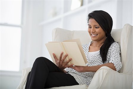 Office Life. A Woman Sitting On A Sofa, Using A Digital Tablet. Stock Photo - Premium Royalty-Free, Code: 6118-07122428