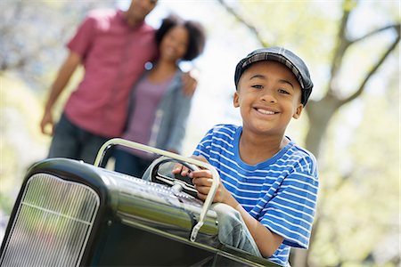 simsearch:6118-07354682,k - A Boy Riding An Old Fashioned Toy Peddle Car. Stock Photo - Premium Royalty-Free, Code: 6118-07122507