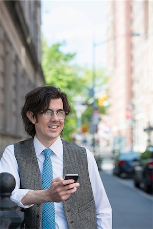 simsearch:6118-07440408,k - A Young Business Man On The Street Checking His Smart Phone. Stock Photo - Premium Royalty-Free, Code: 6118-07122782
