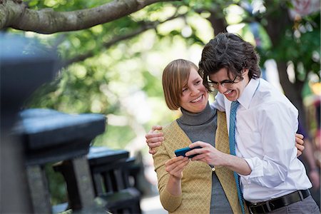 simsearch:6118-07121866,k - City. Two People, A Man And Woman Outdoors, Looking At A Smart Phone Together. Stock Photo - Premium Royalty-Free, Code: 6118-07122798