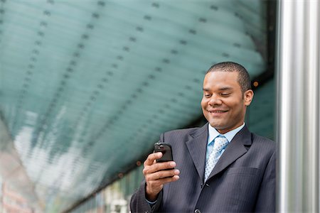 simsearch:6118-07121993,k - City. A Man In A Business Suit Checking His Messages On His Smart Phone. Stock Photo - Premium Royalty-Free, Code: 6118-07122840