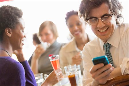 simsearch:6118-07122298,k - City Life. A Group Of People In A Café, Checking Their Smart Phones. Stock Photo - Premium Royalty-Free, Code: 6118-07122824