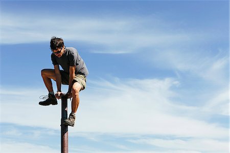 simsearch:6118-09039107,k - Man climbing on to the top of a metal post, on Surprise Mountain, Alpine Lakes Wilderness, Mount Baker-Snoqualmie National forest. Stock Photo - Premium Royalty-Free, Code: 6118-07202954