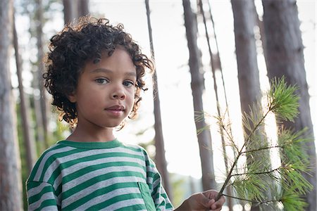 simsearch:6118-08521813,k - Trees on the shores of a lake. A child standing among the trees, holding a branch with yellow pine needles. Stock Photo - Premium Royalty-Free, Code: 6118-07203069