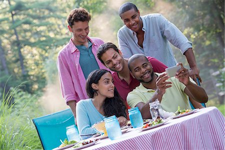 simsearch:6118-07203820,k - A group of people having a meal outdoors, a picnic. Men and women. Stock Photo - Premium Royalty-Free, Code: 6118-07203548