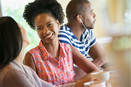 simsearch:6118-07203820,k - Three people in a room, one wearing headphones and two in conversation. Stock Photo - Premium Royalty-Free, Code: 6118-07203788