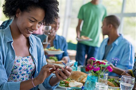 farm phone - A group of women and men around a table sharing a meal in a farmhouse kitchen. Stock Photo - Premium Royalty-Free, Code: 6118-07203828