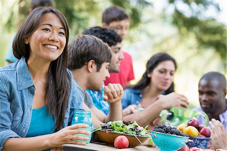 Adults and children around a table at a party in a garden. Stock Photo - Premium Royalty-Free, Code: 6118-07351203