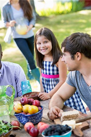 simsearch:6118-07353446,k - Adults and children around a table at a party in a garden. Stock Photo - Premium Royalty-Free, Code: 6118-07351207