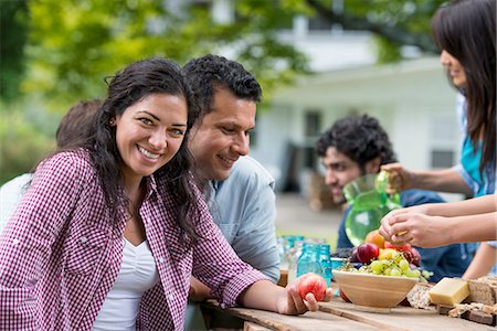 family meals - A summer party outdoors. Friends around a table. Stock Photo - Premium Royalty-Free, Code: 6118-07351219