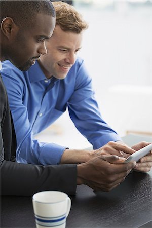 simsearch:6118-07351363,k - Young professionals at work. Two men looking at a digital tablet. Stock Photo - Premium Royalty-Free, Code: 6118-07351362