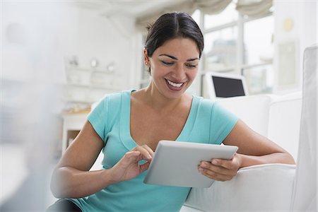 people working, tablet, - Business people. The office in summer. A young woman sitting comfortably in a quiet airy office environment. Using a digital tablet. Stock Photo - Premium Royalty-Free, Code: 6118-07351429