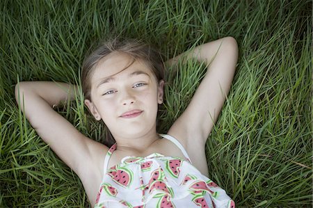 simsearch:6118-07353446,k - A child in the fresh open air on a sunny day, beside solar panels at a farm in New York State, USA. Stock Photo - Premium Royalty-Free, Code: 6118-07351947