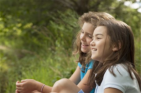 simsearch:649-07596731,k - Two children, girls sitting side by side, laughing in the fresh air. Stock Photo - Premium Royalty-Free, Code: 6118-07352378