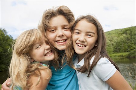 simsearch:649-07596731,k - Three young girls, friends side by side, posing for a photograph in the open air. Stock Photo - Premium Royalty-Free, Code: 6118-07352382
