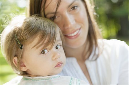 shy baby - A mother and young daughter outdoors on a sunny day. Stock Photo - Premium Royalty-Free, Code: 6118-07352392