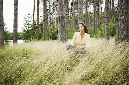 simsearch:6118-08521813,k - A woman in open countryside, by a mountain lake. Stock Photo - Premium Royalty-Free, Code: 6118-07352300