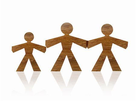 simsearch:6118-07354031,k - Papercuts, paper cut out figures representing people. Two large and one smaller one, family. Stock Photo - Premium Royalty-Free, Code: 6118-07352310