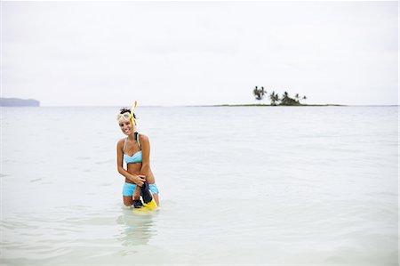 snorkeling woman - A young woman wades in shallow water on the Samana Peninsula in the Dominican Republic. Stock Photo - Premium Royalty-Free, Code: 6118-07352405