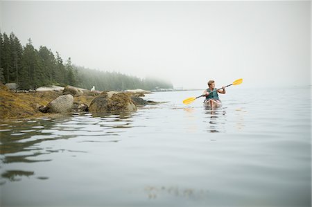 A man paddling a kayak on calm water in misty conditions. New York State, USA Foto de stock - Sin royalties Premium, Código: 6118-07352421