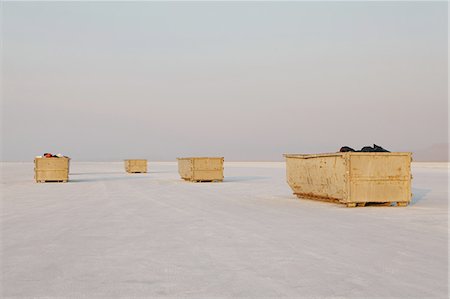 Large yellow garbage containers on Bonneville Salt Flats, dusk, near Wendover. Stock Photo - Premium Royalty-Free, Code: 6118-07352501