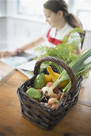 simsearch:6118-08521776,k - Organic Farming. A young girl in a kitchen, with a basket of fresh vegetables. Stock Photo - Premium Royalty-Free, Code: 6118-07352626