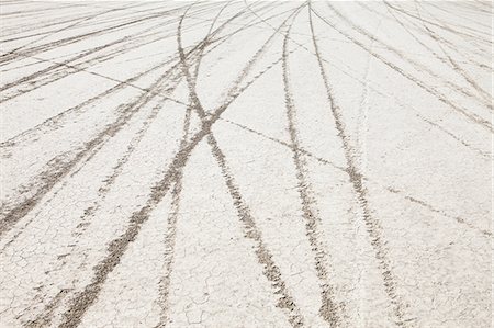 simsearch:6118-07352741,k - Tyre marks and tracks in the playa salt pan surface of Black Rock Desert, Nevada. Stock Photo - Premium Royalty-Free, Code: 6118-07352760