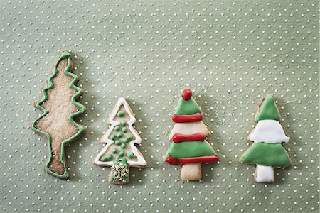 simsearch:6118-07354031,k - Organic homemade Christmas cookies shaped like Christmas trees, iced with green, red and white icing. Stock Photo - Premium Royalty-Free, Code: 6118-07352974