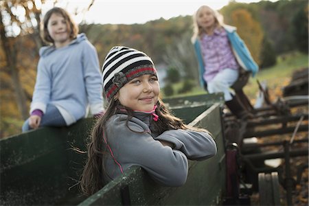 simsearch:6118-07354445,k - Three young girls out and about on the farm. On an old trailer. Stock Photo - Premium Royalty-Free, Code: 6118-07353408