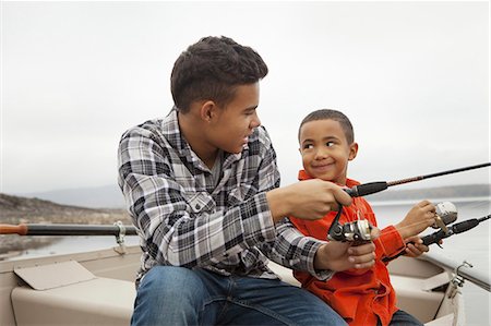 A day out at Ashokan lake. Two boys fishing from a boat. Stock Photo - Premium Royalty-Free, Code: 6118-07353561