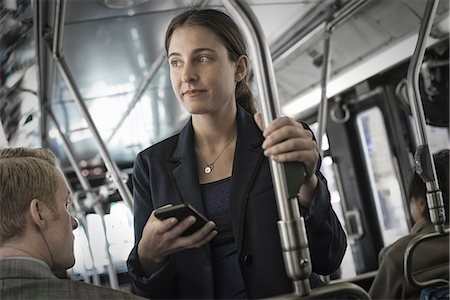 simsearch:6118-07440408,k - Business people in the city. Two people, a man and woman on a bus. Stock Photo - Premium Royalty-Free, Code: 6118-07353637