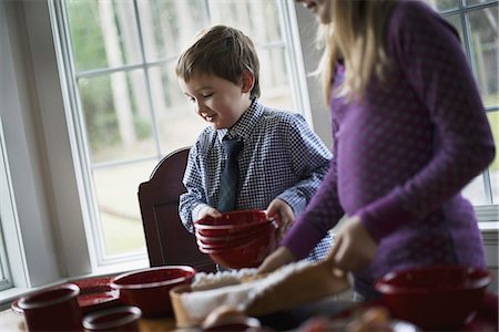 A family home. Two children laying the table with crockery for a meal. Stock Photo - Premium Royalty-Free, Code: 6118-07353744