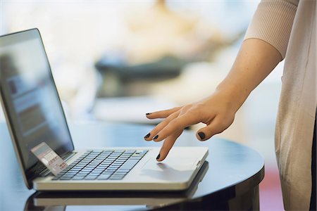 Woman on-line shopping on laptop Stock Photo - Premium Royalty-Free, Code: 6118-07353957