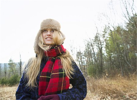 simsearch:6118-07354445,k - A woman in a warm furry hat and a big red tartan scarf, outdoors in the winter. Stock Photo - Premium Royalty-Free, Code: 6118-07354113